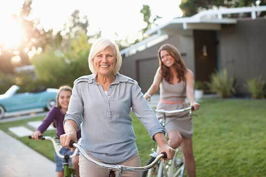 Grandmother out for a bike ride with her daughter and grandaughter